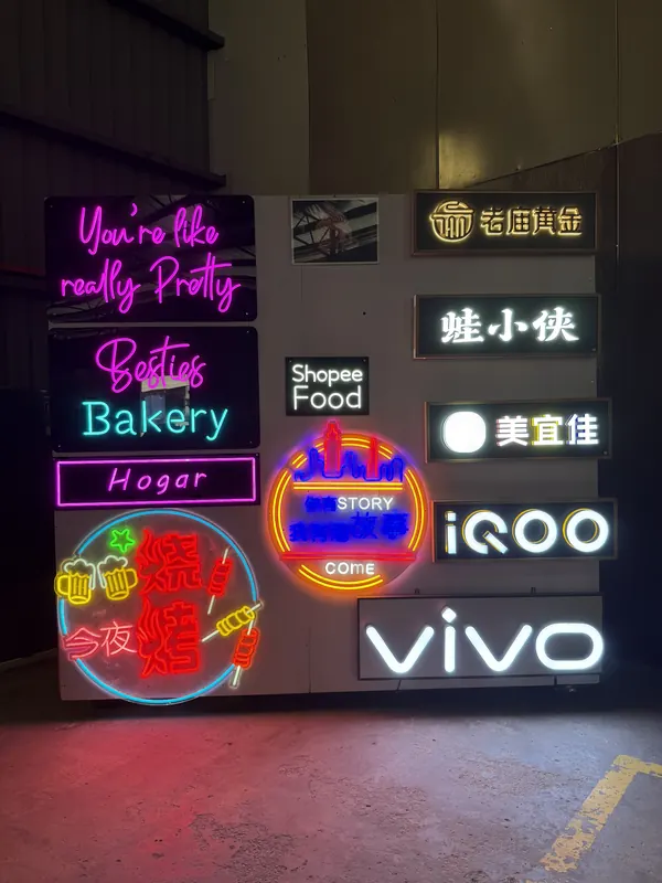 Neon script, outline and Chinese-character signs on our sample wall.